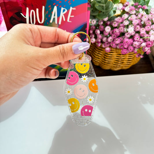 Cute Acrylic Motel Keychain – Glitter Clear with Colorful Smiley Faces